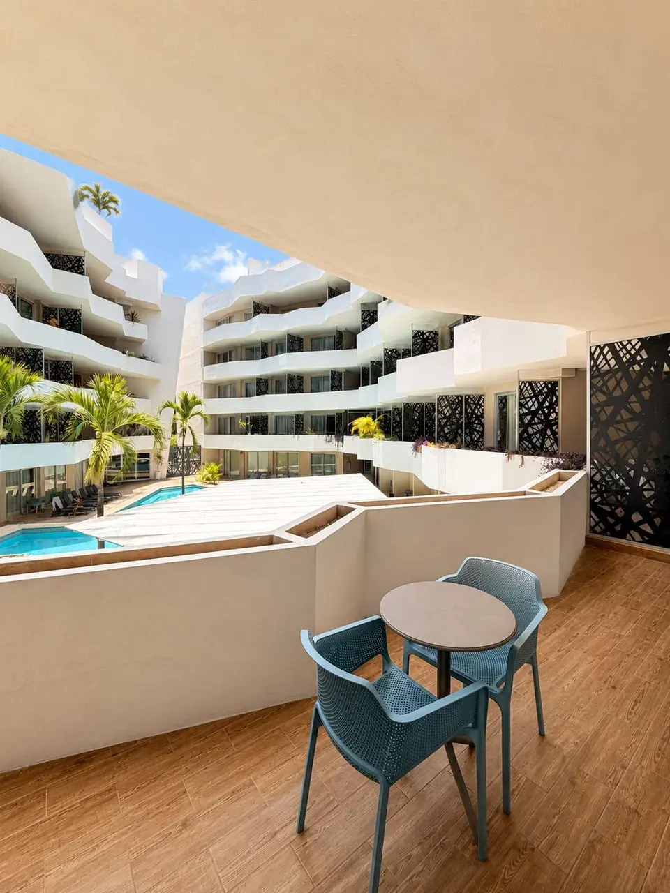 A private balcony overlooking the main pool, ideal for slow mornings, an outdoor coffee, or unwinding in a quieter setting after exploring Playa del Carmen.