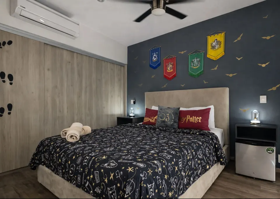 Bright and cozy room filled with natural light, featuring a mini fridge and magical details for a truly enchanting stay.