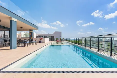 Relax by the rooftop pool; ocean views guaranteed.