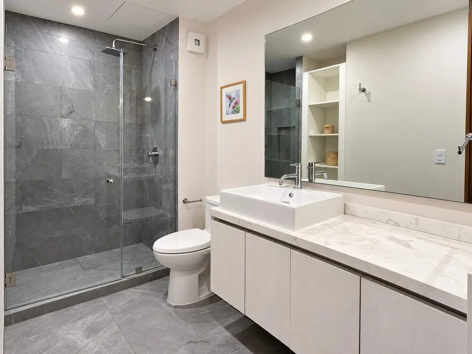 The bathroom is spacious and features a minimalist design.