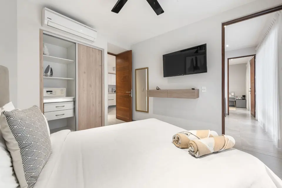 Relax in style with a queen bed, TV, and private access to the poolside patio.