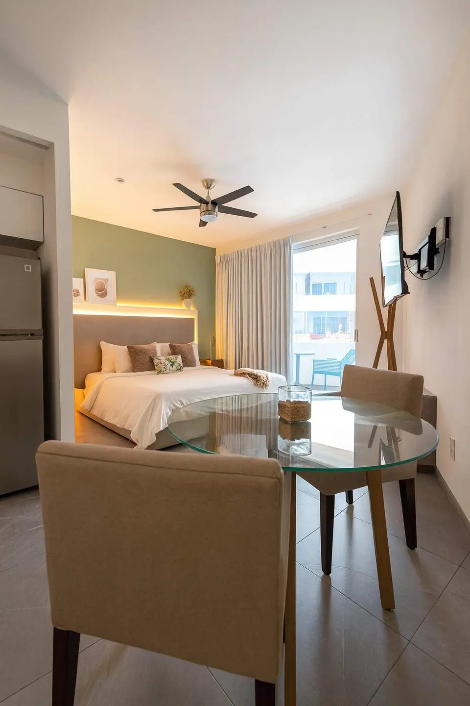 Enjoy a spacious, bright studio with a dining table just steps from your cozy bed.