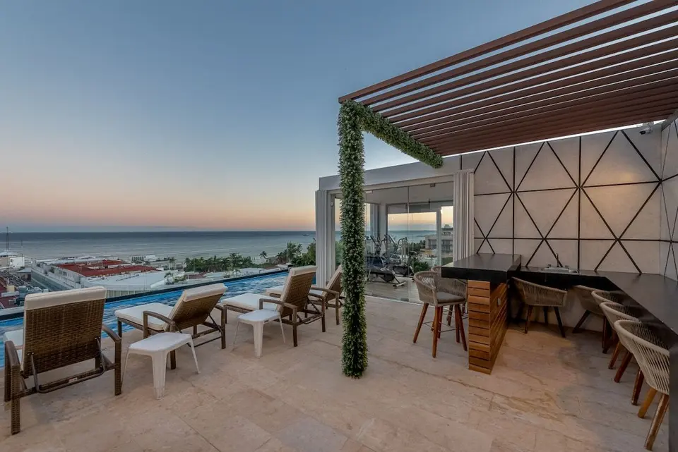 Enjoy the sunset on our oceanfront rooftop, with comfortable sun loungers.