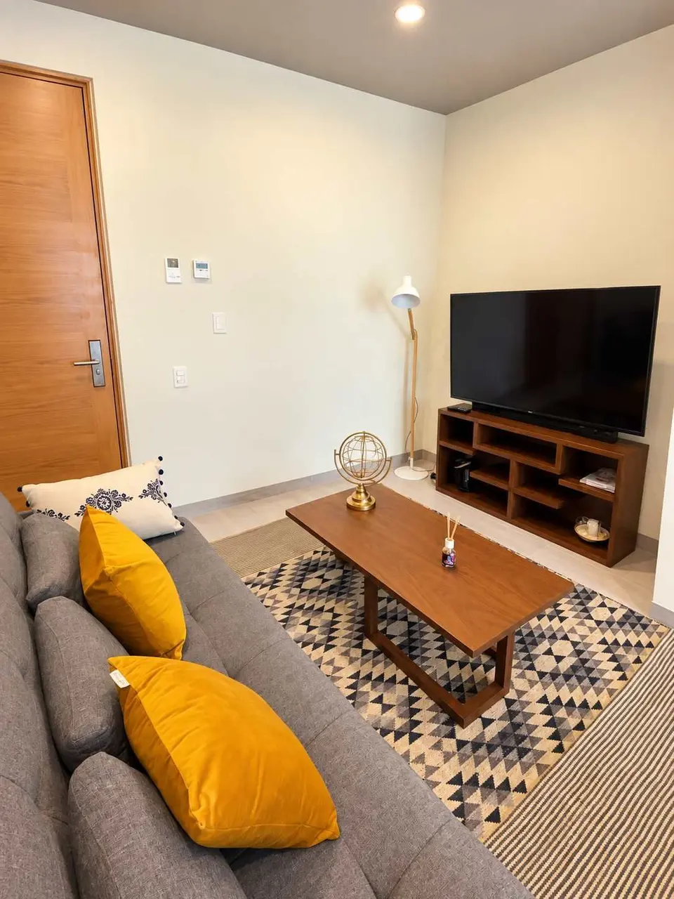 The living room features all amenities (high-definition TV, high-speed internet, and a sofa bed).