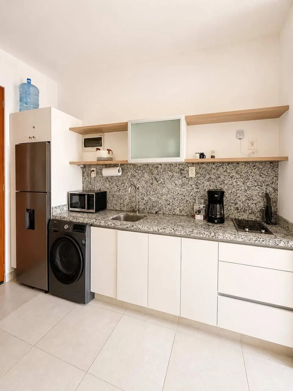 A practical, well-equipped kitchen designed to make you feel at home, complete with a full-size refrigerator and washer-dryer for an easier, more comfortable stay.